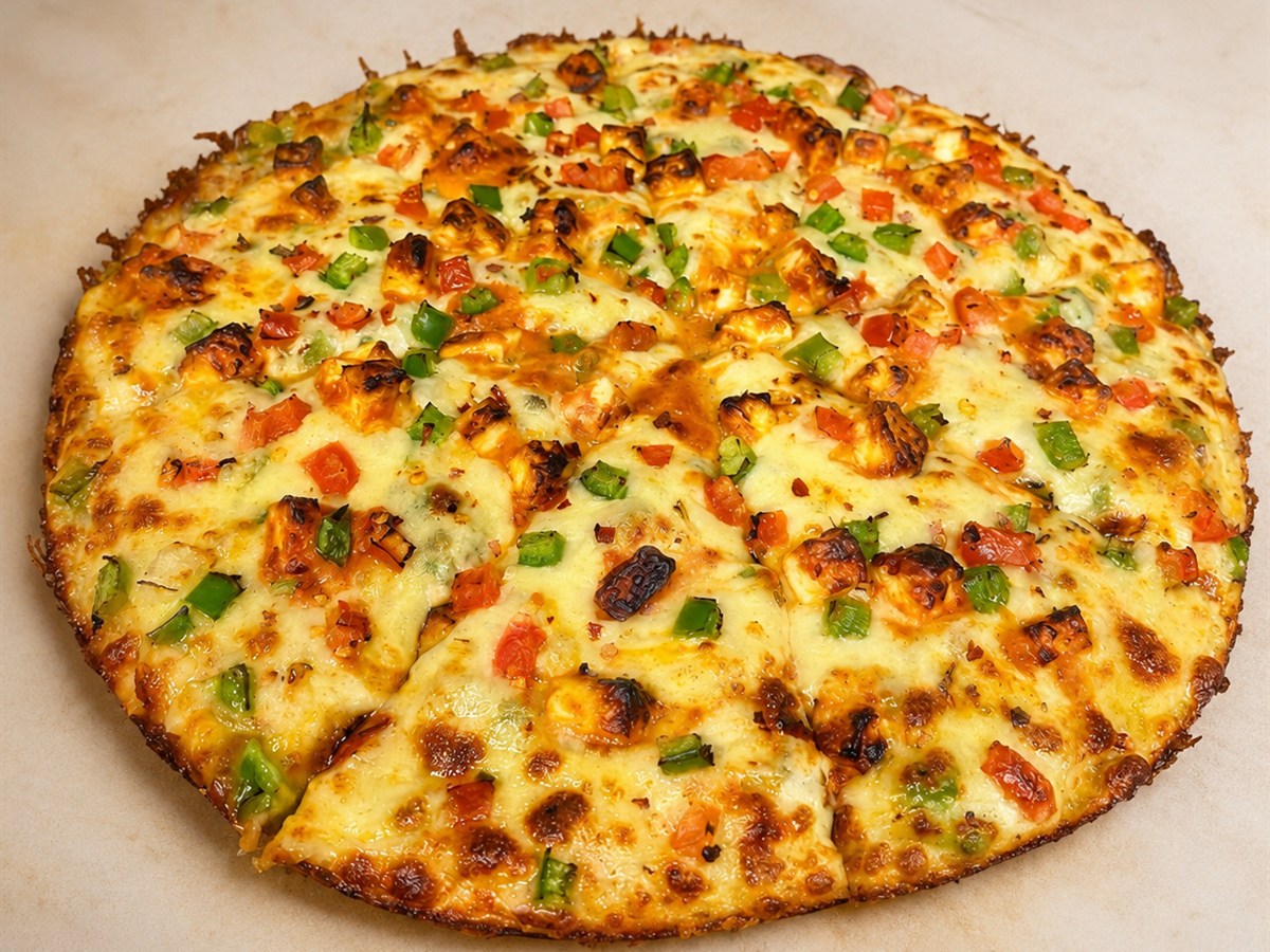 Shahi Paneer Pizza with paneer, green pepper, tomato and chili flakes